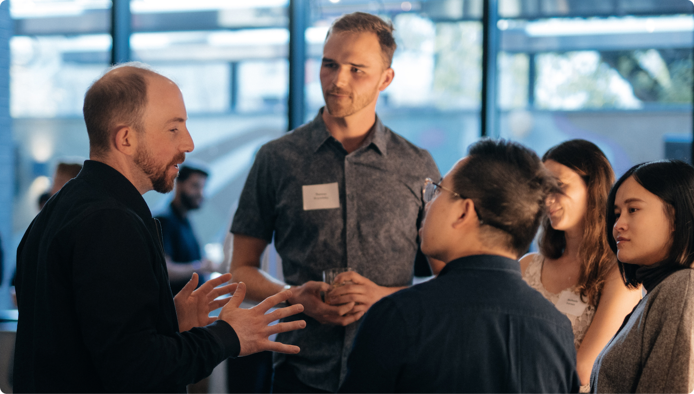 Mike Katchen, CEO of Wealthsimple, speaking to a small group of clients at an in-person event