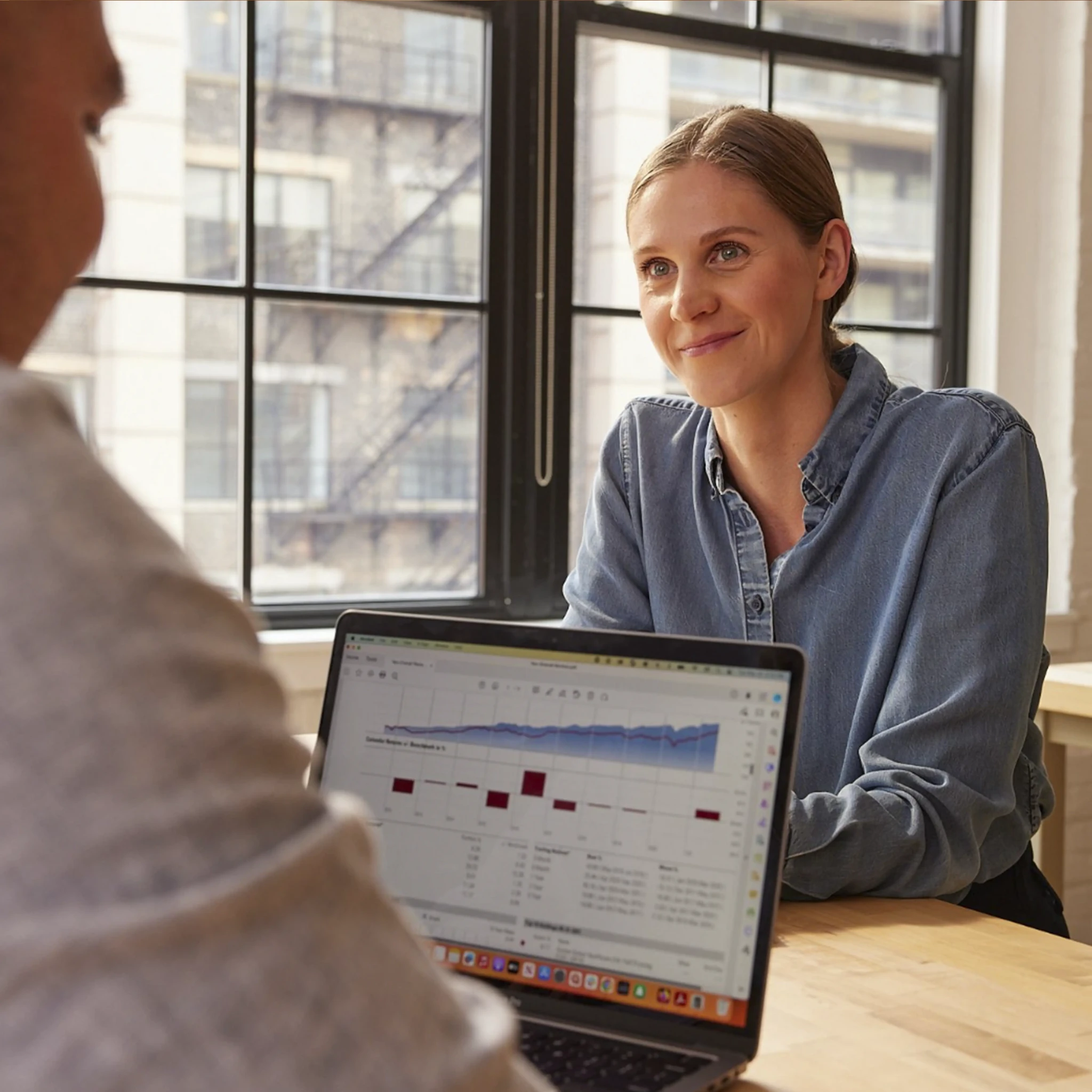 A Wealthsimple advisor sitting at a desk with a laptop open to a portfolio
