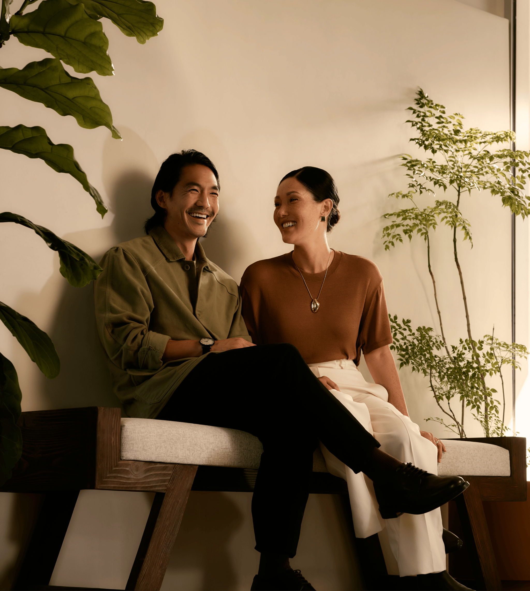 Un couple souriant assis sur un banc