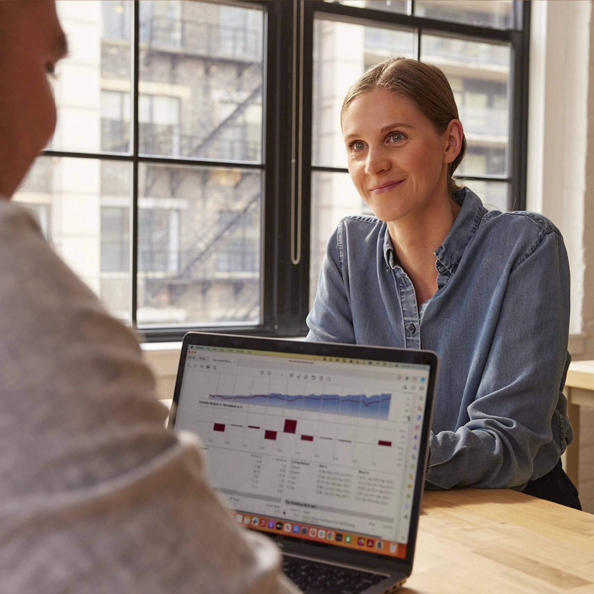A Wealthsimple advisor sitting at a desk with a laptop open to a portfolio