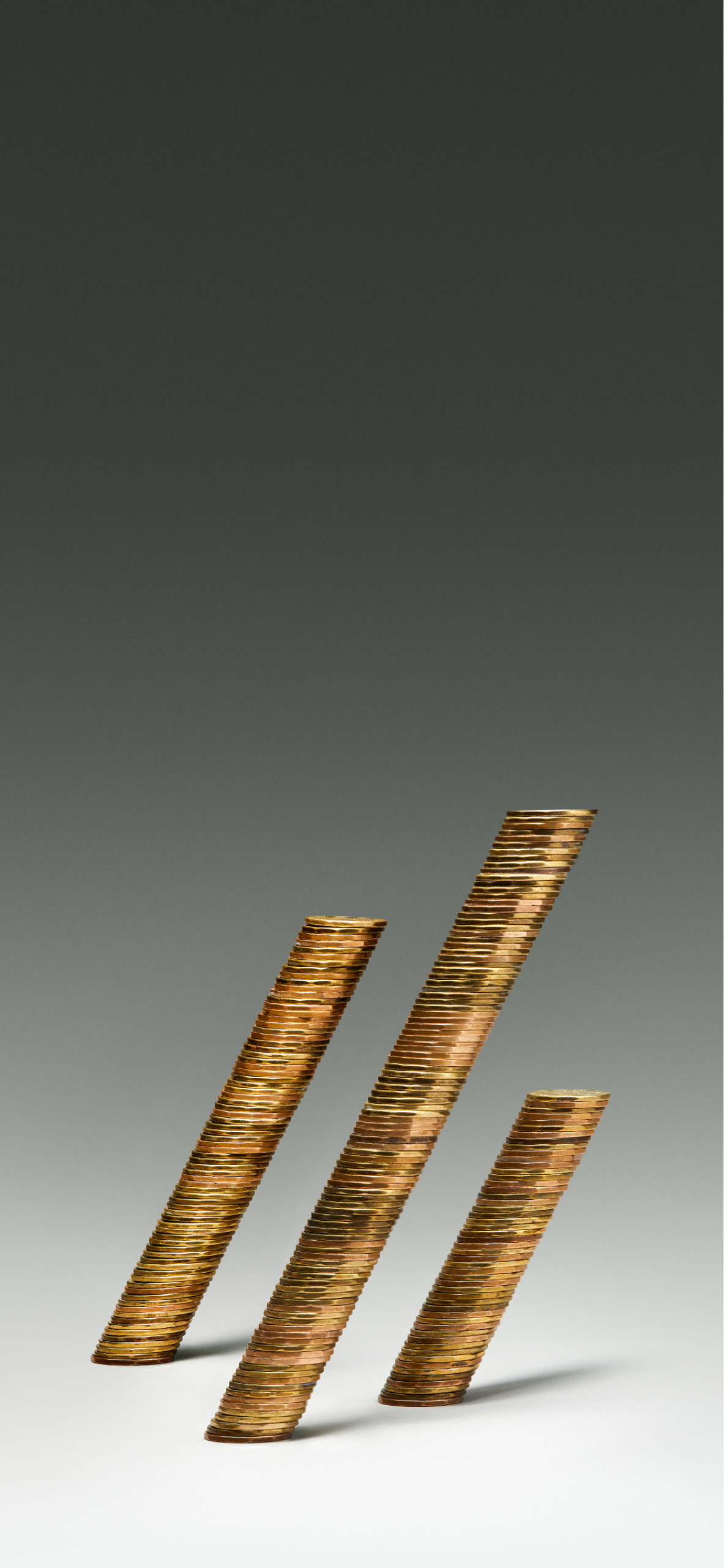Three stacks of coin leaning forward.