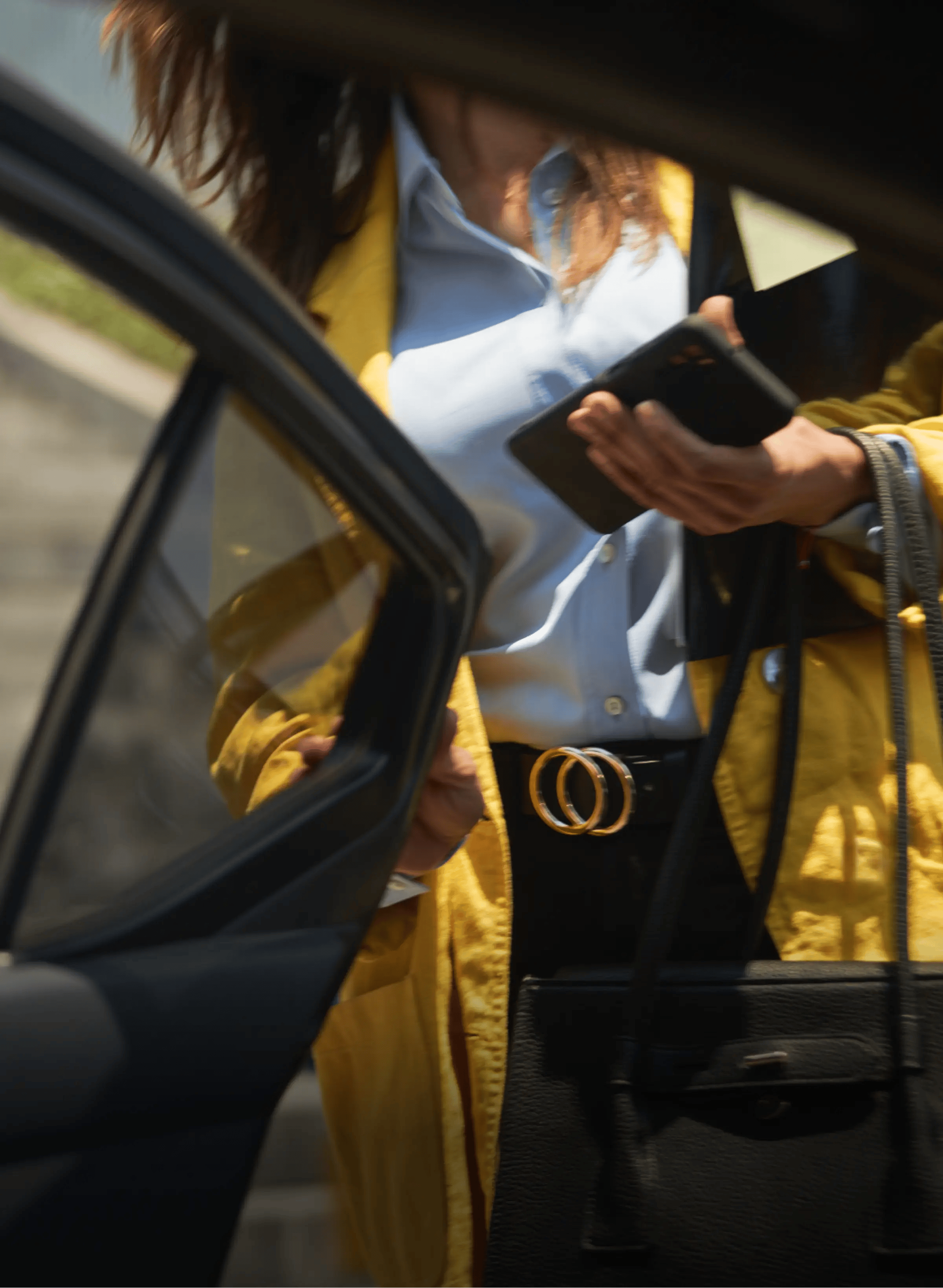 A woman getting into a car
