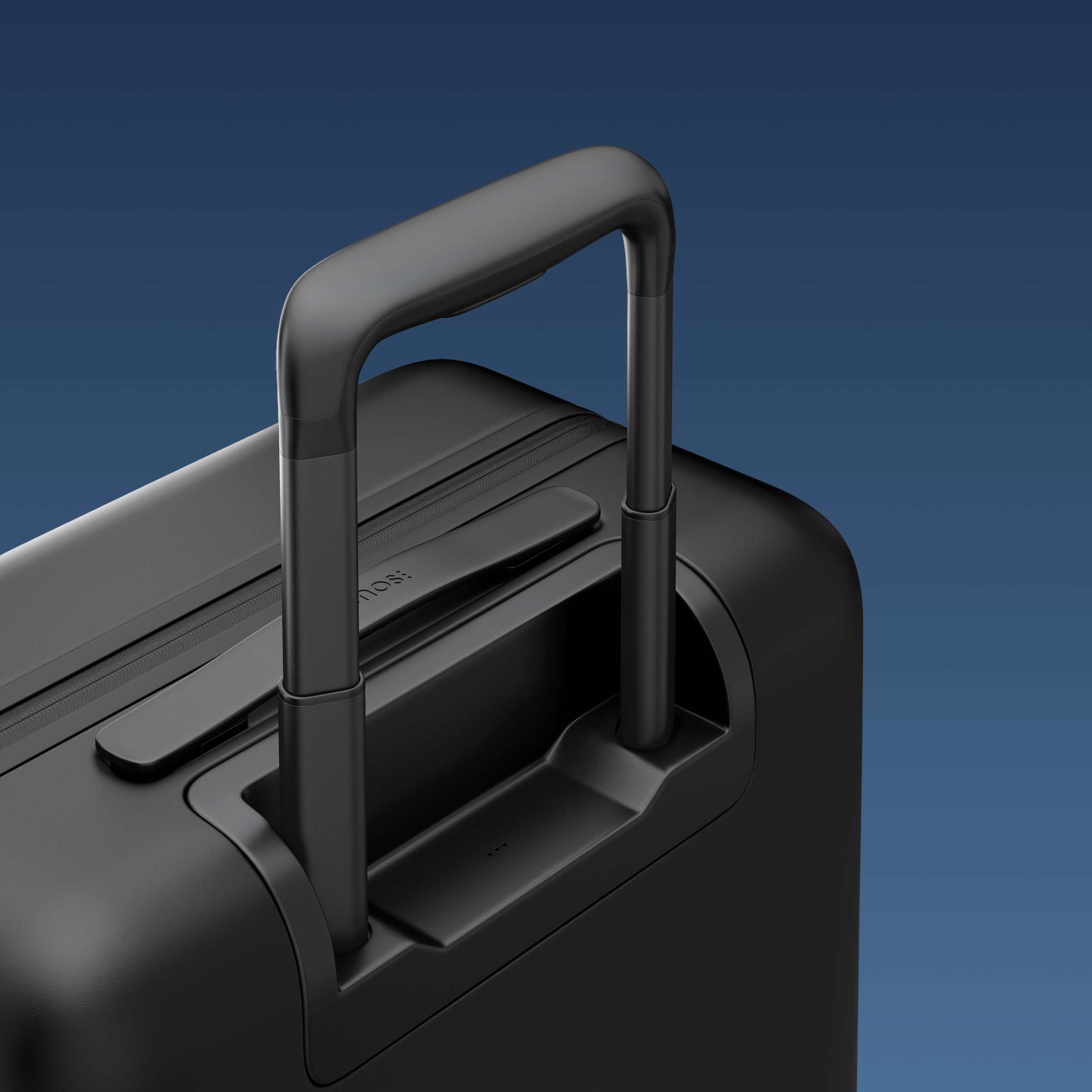 A close up of the Monos Carry-On Pro. It's a dark black, with a pocked on the front. It's sleek.