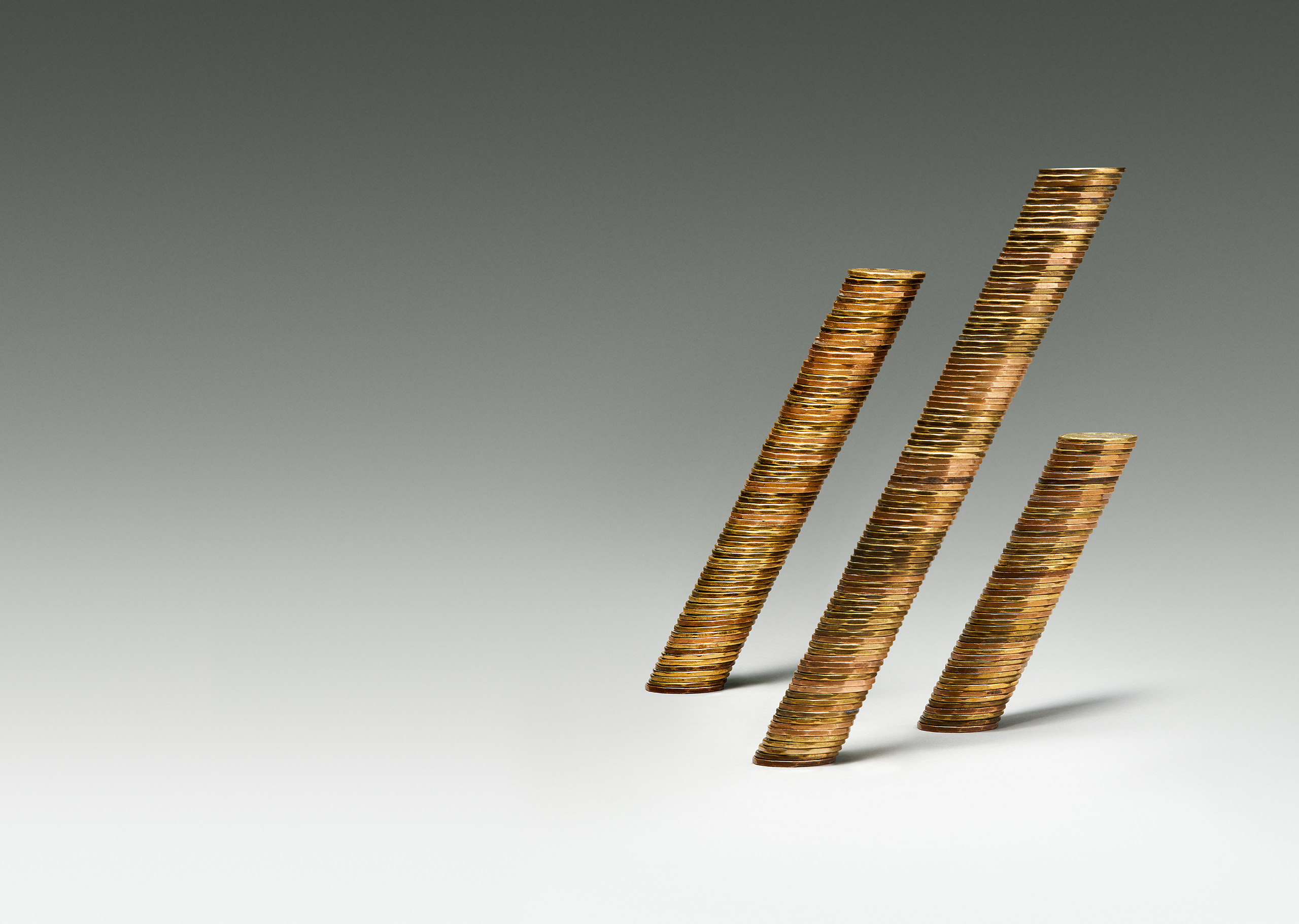 Three stacks of coin leaning forward.