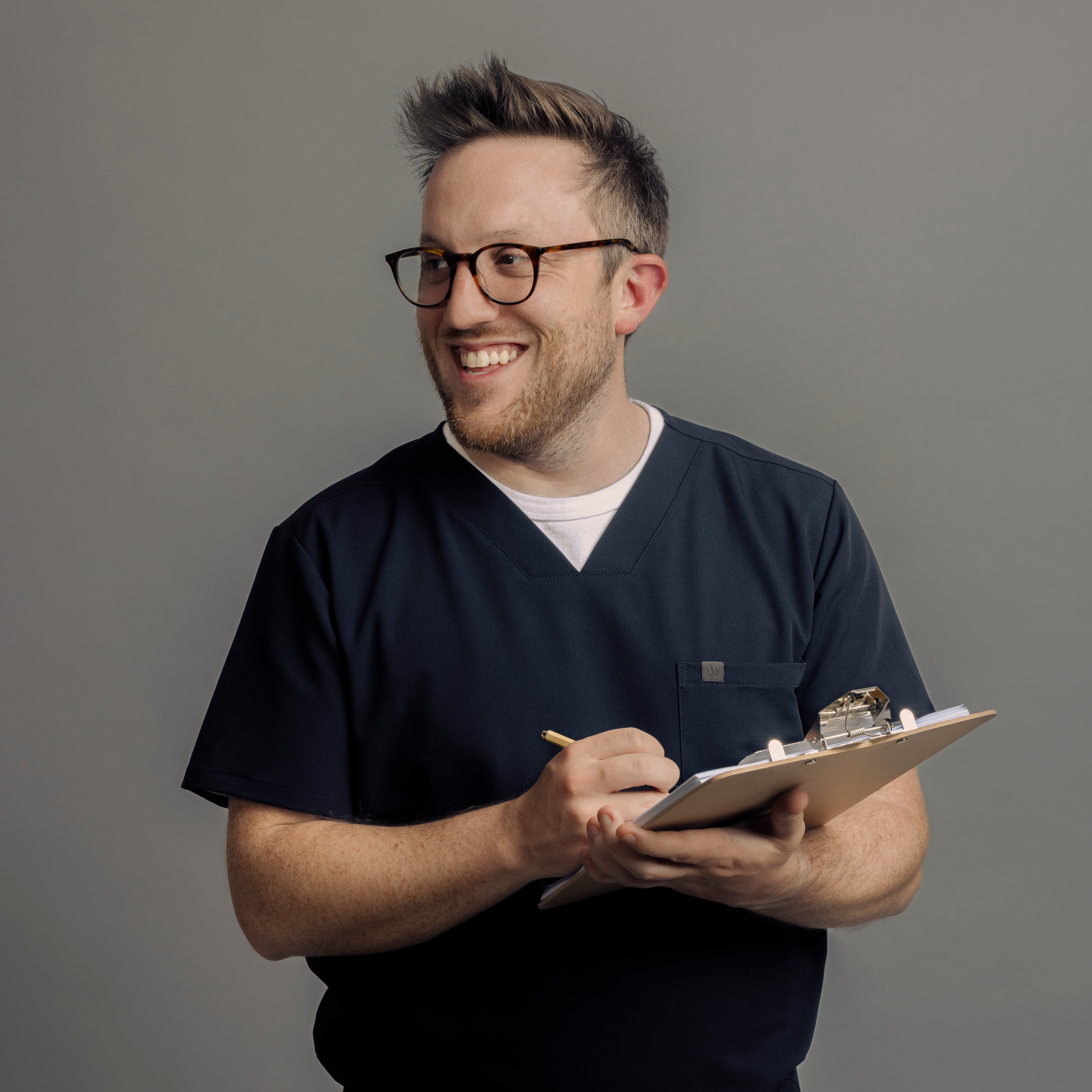 A man with a clipboard in Wealthsimple scrubs.